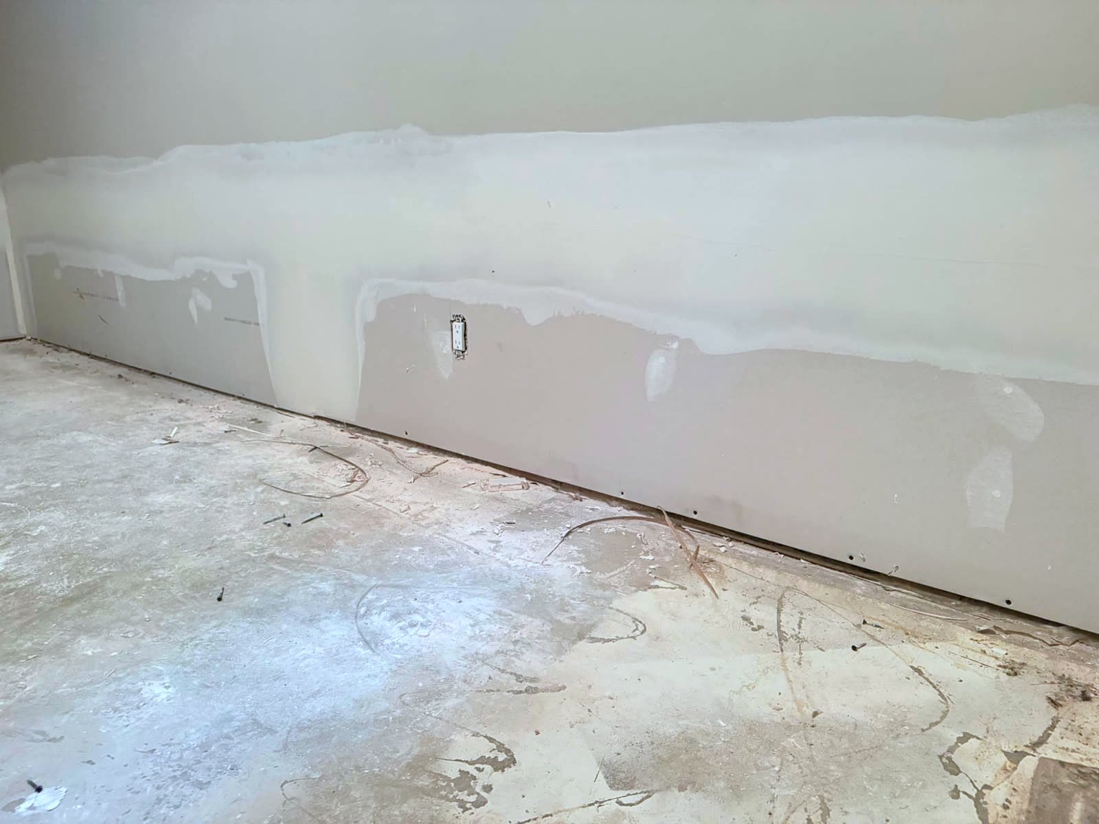 Lower wall taped and mudded after drywall replacement